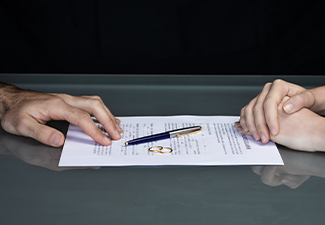 Couple goes through divorce signing papers. High quality photo