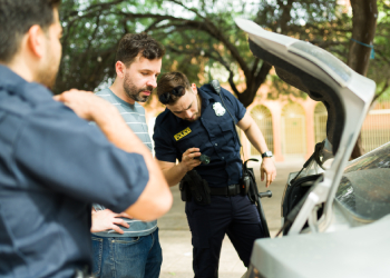 Police searching car trunk for criminal evidence
