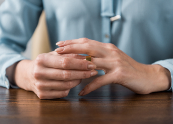 Woman taking off wedding ring