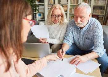 Old couples signing Advanced Directive paper