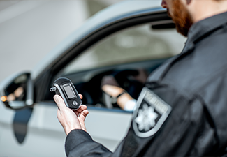 Policeman holding device for checking alcohol intoxication