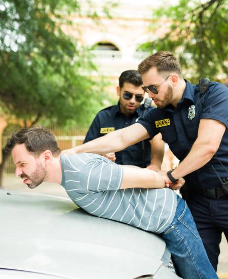 Two officers arresting a man