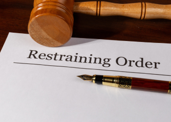 Restraining Order Document on the Desk with Gavel and Pen