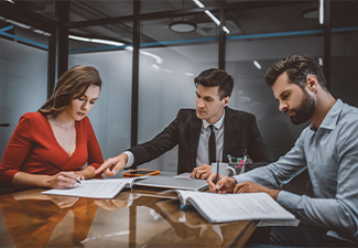 Professional lawyer consulting spouses about legal documents
