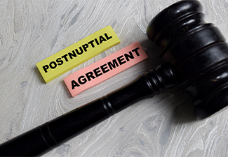 Concept of postnuptial agreement write on sticky notes isolated on Wooden Table