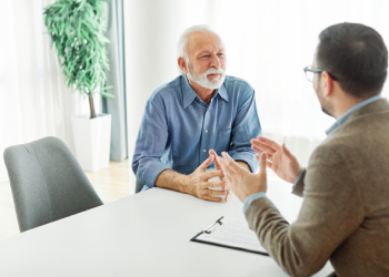 Old man consulting with attorney