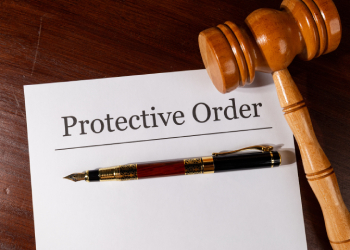 Protective Order file on table with gavel and pen