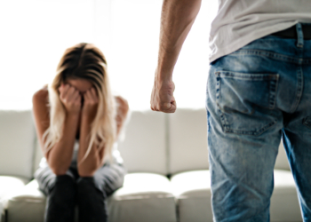 Closed fist of a man with crying women