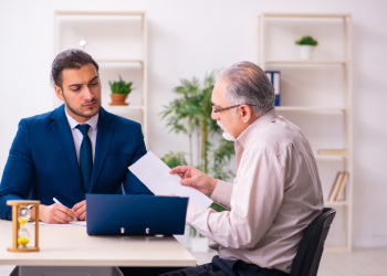 Old man consulting with attorney on will contest