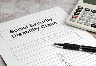 Disability claim form social security desk with calculator and pen