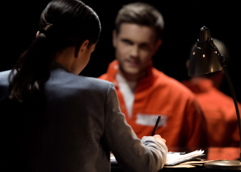 Defense attorney writing statement of accused prisoner