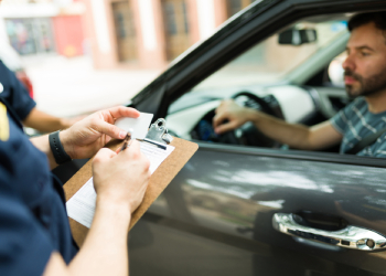 Police officer writing speeding ticket