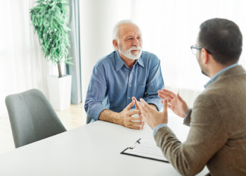 Old man consulting with attorney