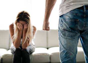 Man with closed fist and crying women