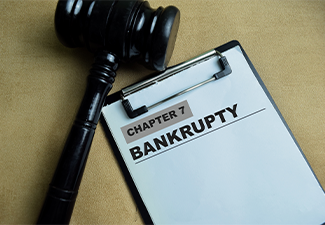 Concept of Chapter 7 Bankrupty write on paperwork isolated on wooden background