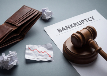 Empty purse, downfall graph and gavel on top of Bankruptcy paper