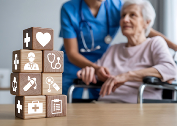 Senior women cared by nurse and wooden blocks with health care related icons