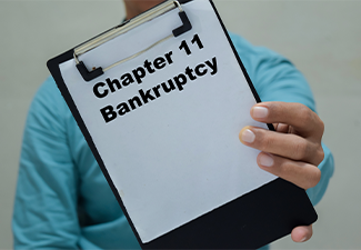 Businessman holds in hands a clipboard with the name of the chapter 11 bankruptcy