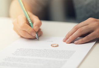 Woman signing marriage divorce papers
