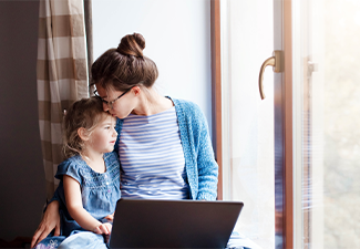 Woman and cute child sitting on window sill