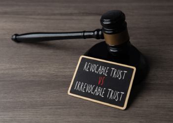 Judge gavel with a sign showing revocable trust versus irrevocable trust