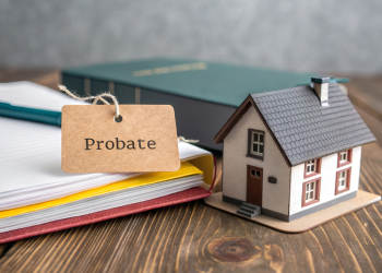 Paper tag labeled 'Probate' on top of legal document with house model