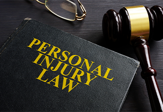 Personal Injury Law book and a black desk