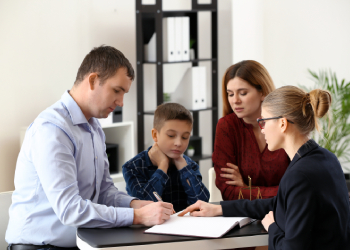 Divorced parents with child meeting with family law attorney