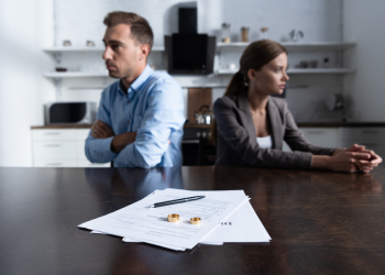 Couples with divorce paper in table