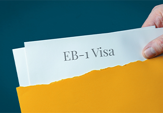 Hand opens envelope and takes out documents of EB-1 Visa