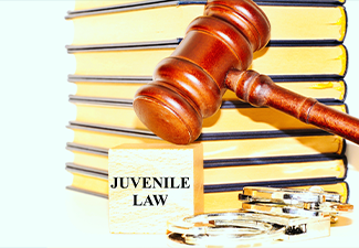 Judge's gavel , books, handcuffs and the word 'Juvenile Law'
