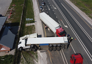 Top view of a car accident involving a truck and a bus