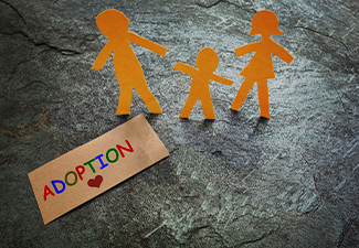 Paper family with word adoption on table