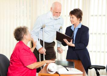 Injured man and his wife consulting with attorney