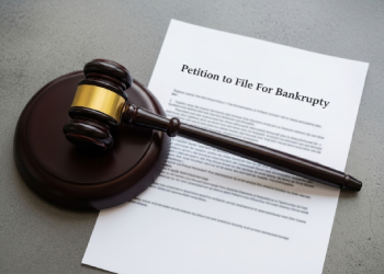 Gavel resting on a petition to file for bankruptcy document