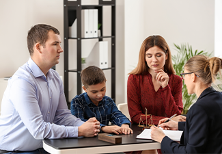 Divorced parents with their son visiting lawyer