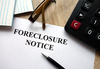 Foreclosure notice with pen, calculator and glasses in office