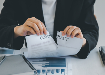 Women tearing contract paper