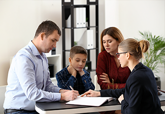 Divorced parents with their son visiting lawyer