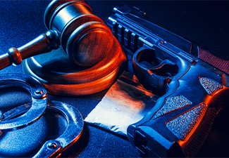 Judge gavel, handcuffs with white powder bag on dark table