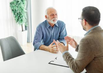 Old man consulting with attorney