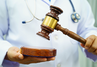 Asian doctor holding court hammer for and crime law justice