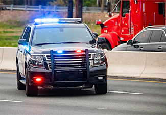 Road patrol police car on highway scene with emergency lights