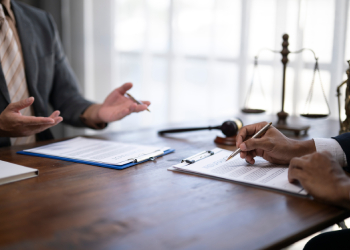 Businessman with attorney reviewing business contract