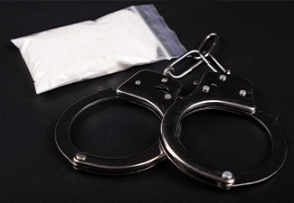 Handcuffs and white powder closeup ,drug arrest