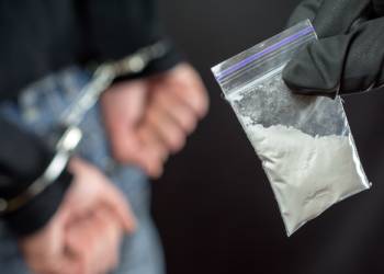 Handcuffed man for drug charges