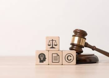 Gavel and wooden blcoks with logo related to IP
