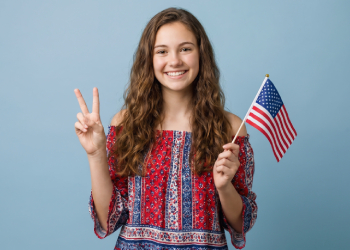 Teenage girl holding American flag