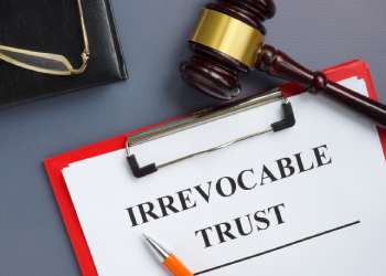 Irrevocable trust document on the clipboard and gavel