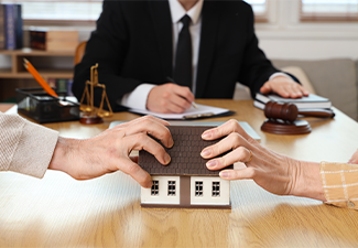 Mature couple dividing house at divorce lawyer's office, closeup